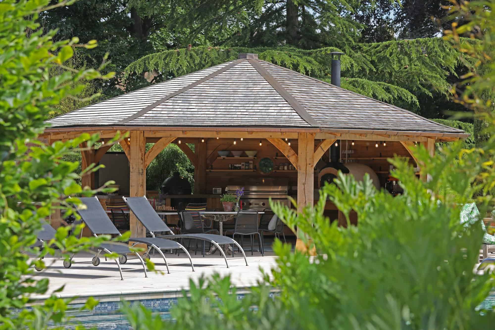 Poolside wooden structure through shrubbery